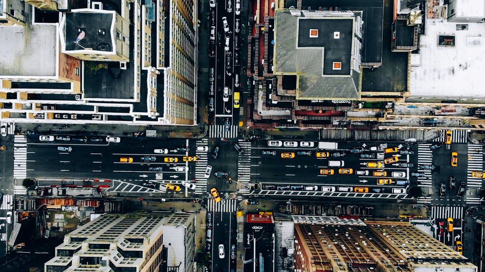 Aerial view of intersection in a city with lots of cars and taxis stuck in traffic
