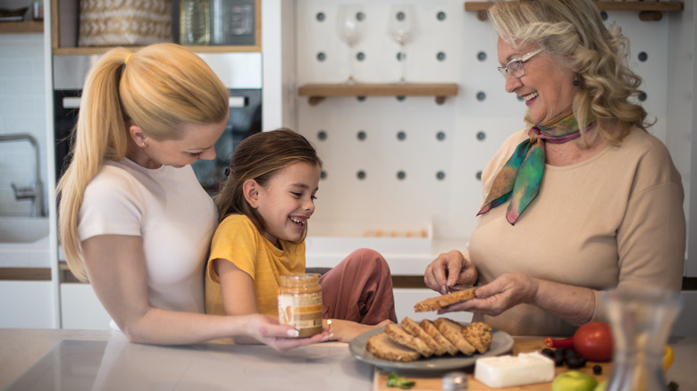 family making peanut butter sandwiches