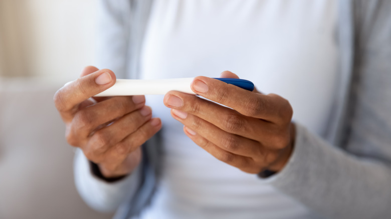 woman reading pregnancy test 