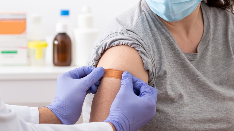 doctor gives woman a shot 