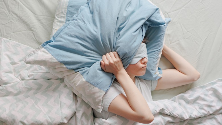 Person with pillow over head