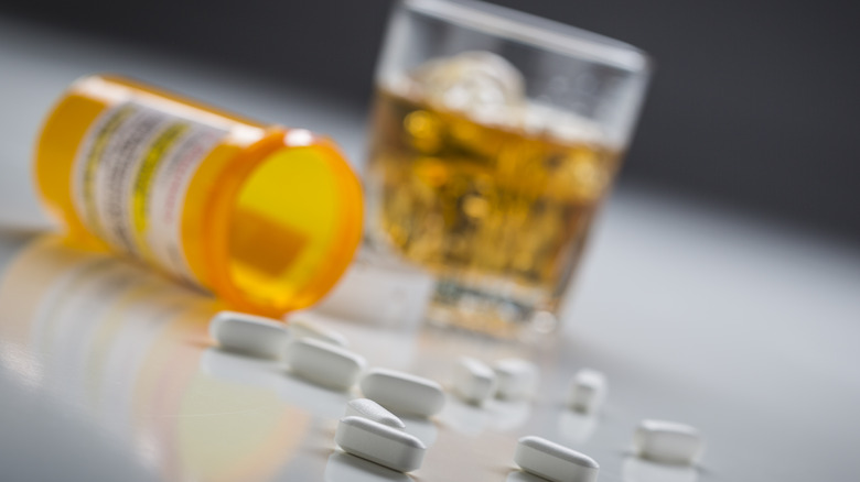Tablets with alcohol in the background