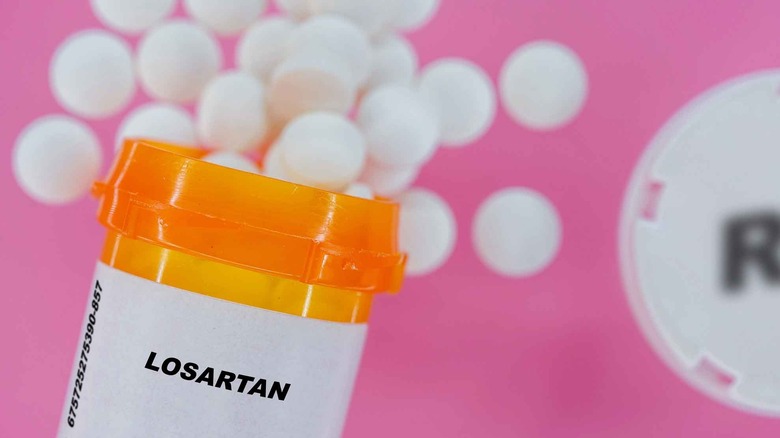 Losartan tablets on pink background