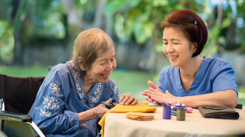 Elderly woman with caregiver