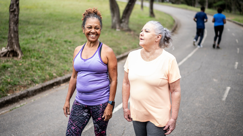 two women walking in a park