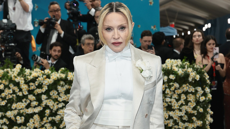Madonna posing in a white suit