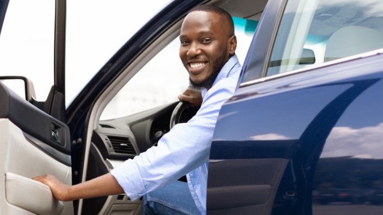 Man opening door of car