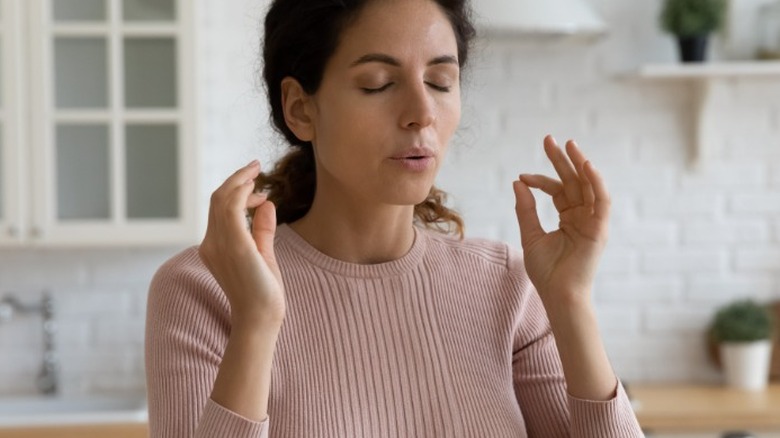 Young woman doing breathing exercise