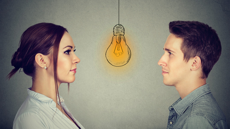 man and woman with animated light bulb between them