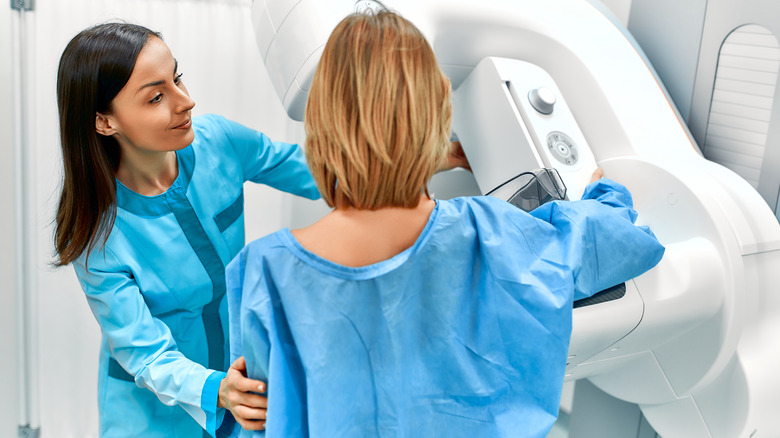 woman and doctor in front of mammogram machine