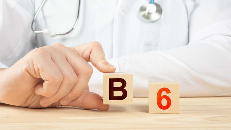 Doctor with blocks showing B and 6