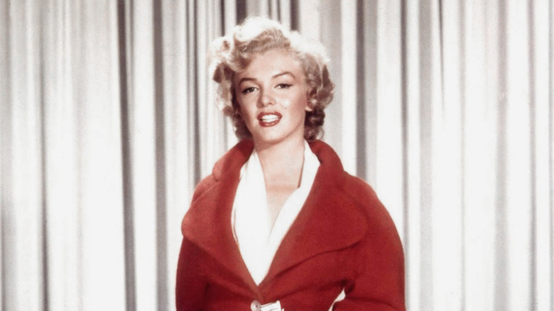Marilyn Monroe posing in a red jacket