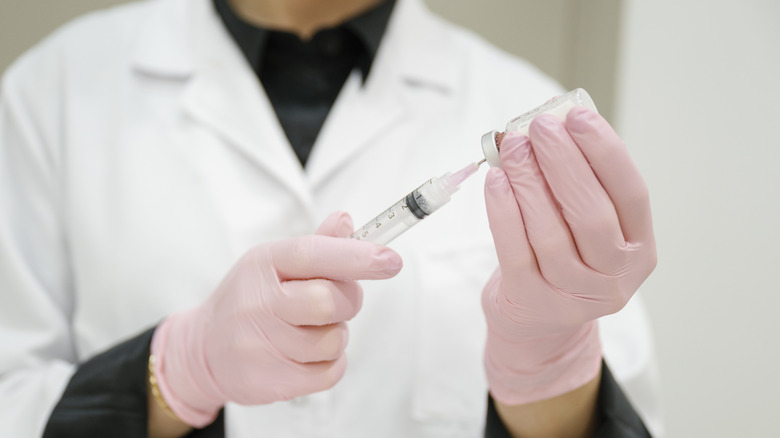 medical staff preparing a needle