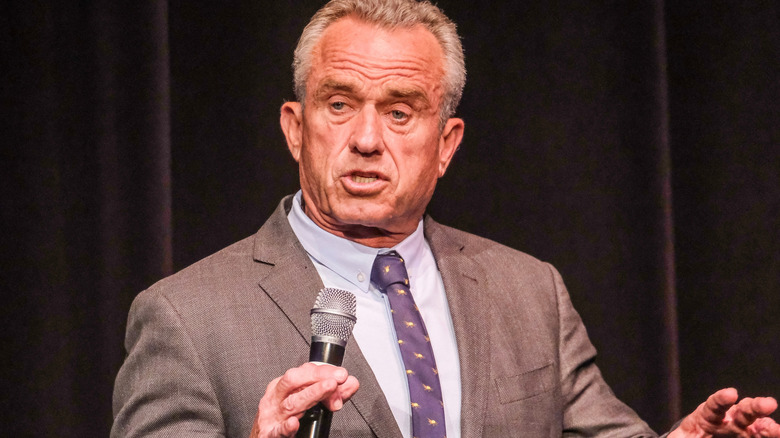 Robert Kennedy Jr. holding a microphone and talking