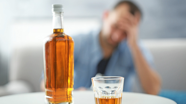 Alcohol with man suffering from migraine