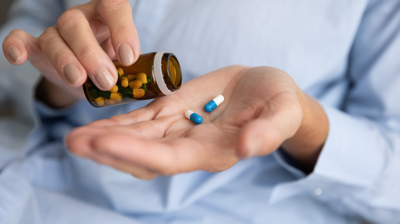 Person pouring out pills into their hand