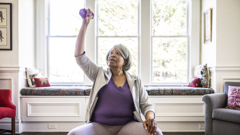 woman exercising in her home with weights