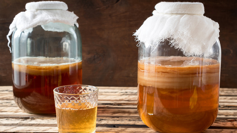 Jars and glass of kombucha