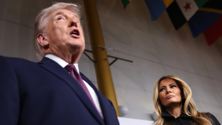 Melania Trump watching as Donald Trump talks during an event