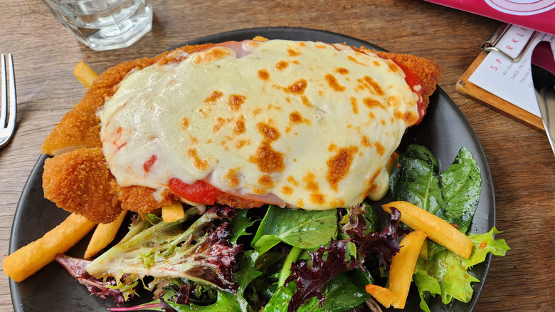 Chicken parmigiana on a bed of leaves