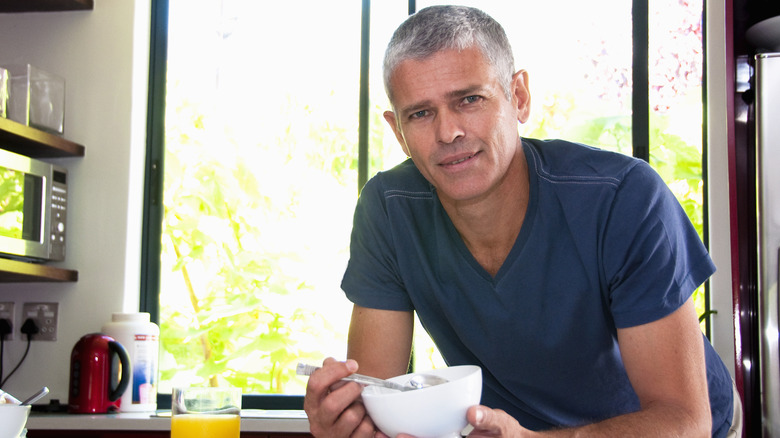 older man eating breakfast