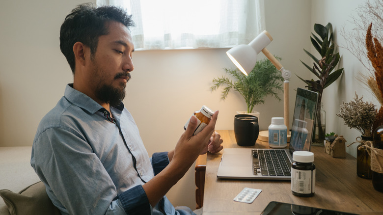 Man looking at prescription drug label