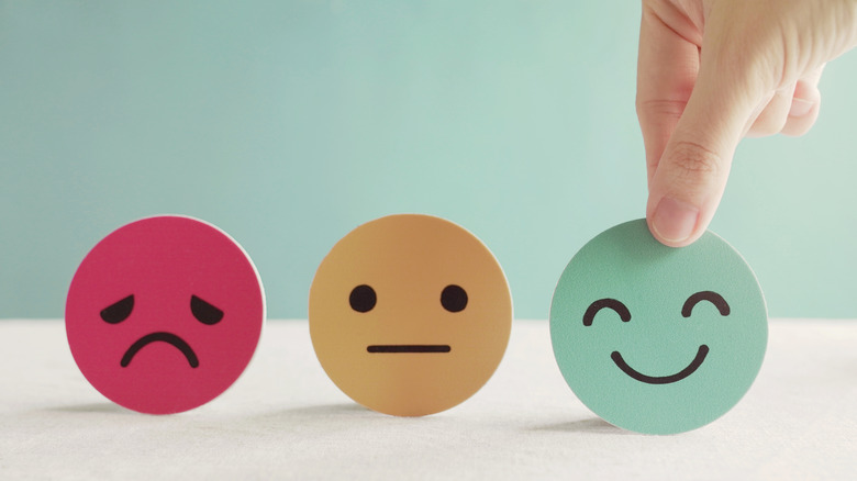 Three hard copy emoji faces