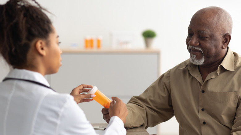 Doctor prescribing medication to patient
