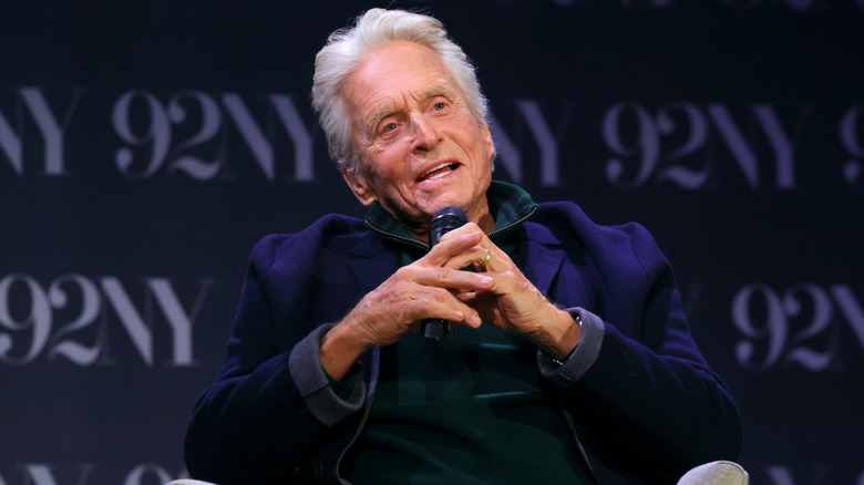 Michael Douglas speaking into a microphone