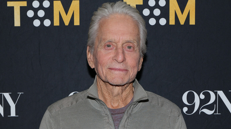 Michael Douglas wearing a gray outfit on a red carpet