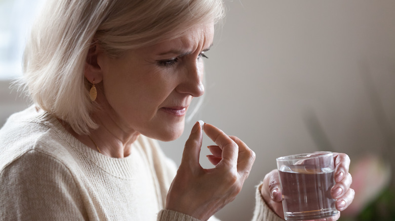 senior woman taking pill