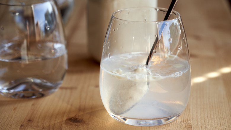 glass of water with powder mixture