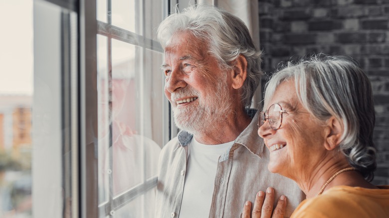 happy older adults looking out the window