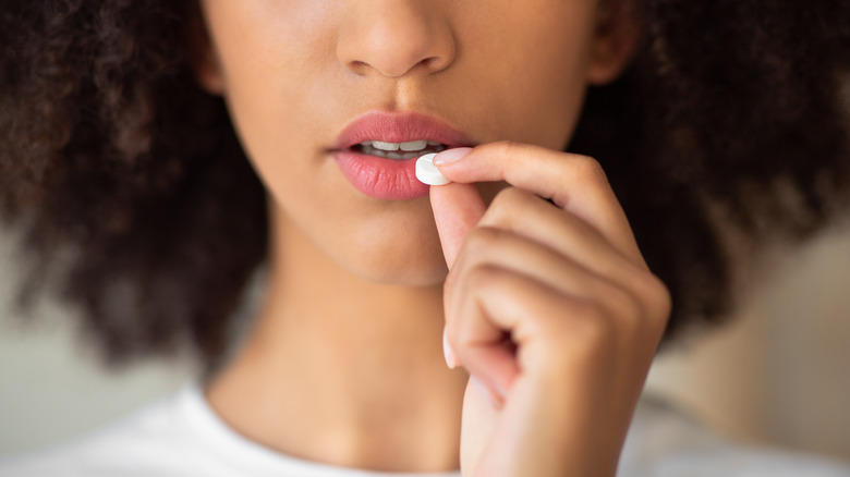 woman taking pill