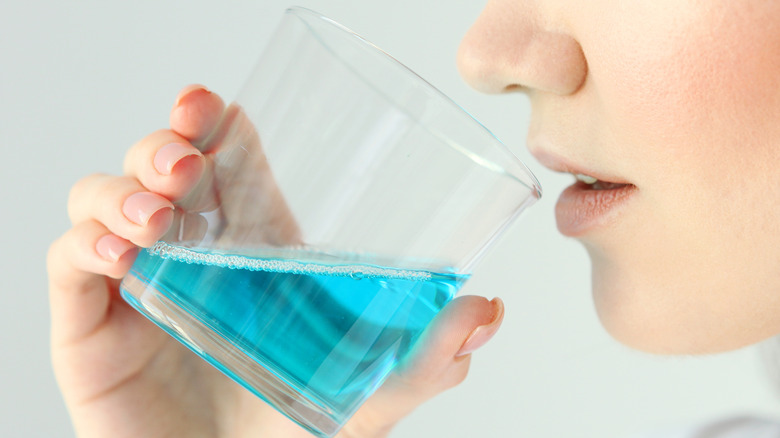 Close-up of a person about to use mouthwash