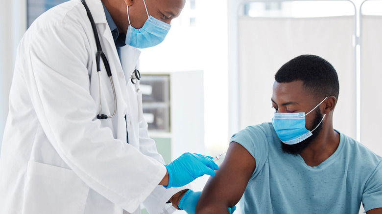 Doctor giving patient COVID vaccine