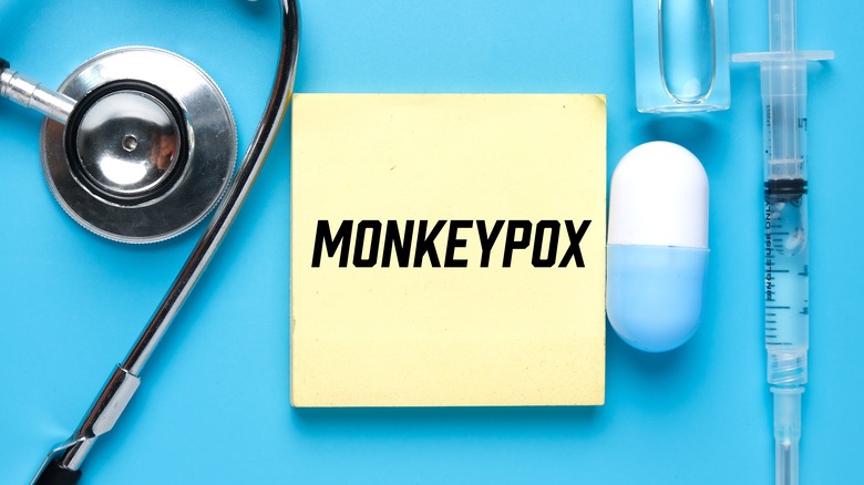 "Monkeypox" written on a yellow sticky note