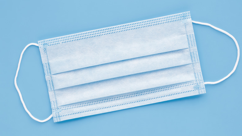 Surgical mask against light blue background