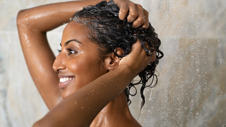 Woman shampooing hair