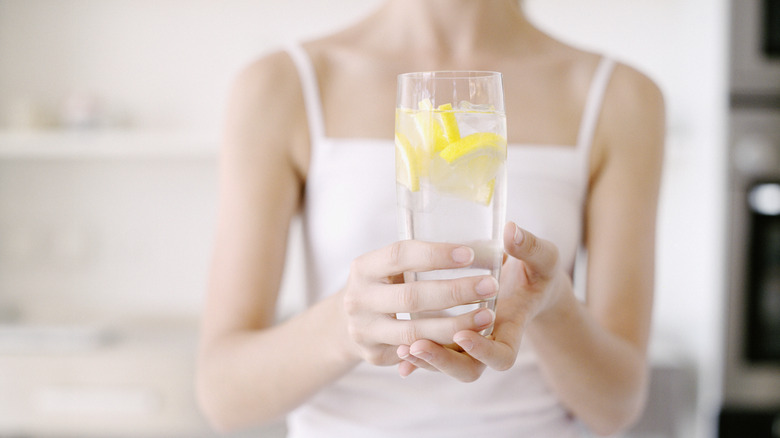 Hands holding glass of water