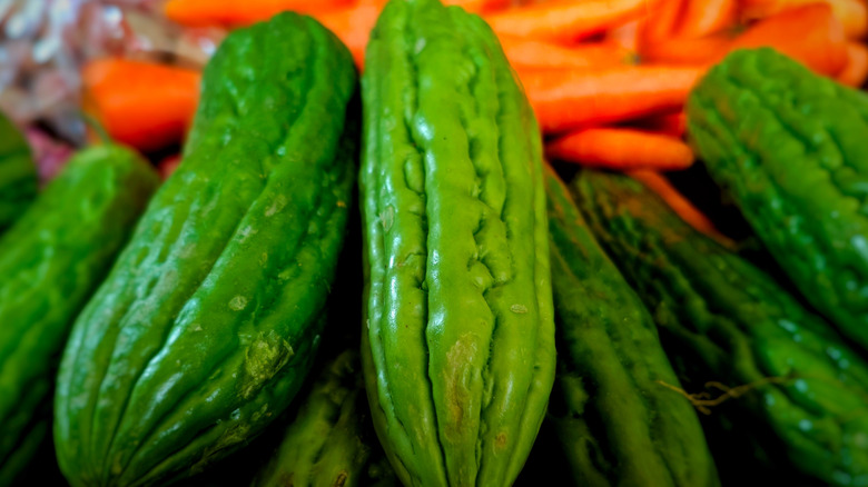 Bitter melon gourds on a market shelf