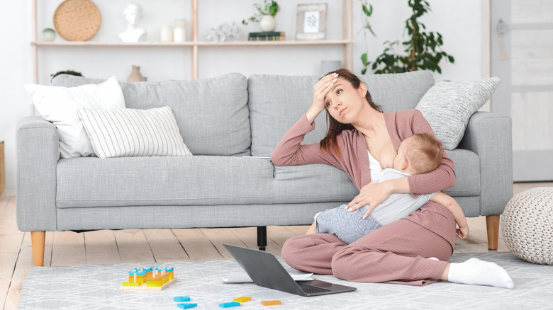 A mom frustrated while breastfeeding