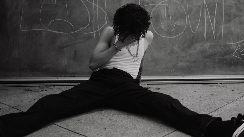 Jacob Sartorius sitting in front of a chalkboard