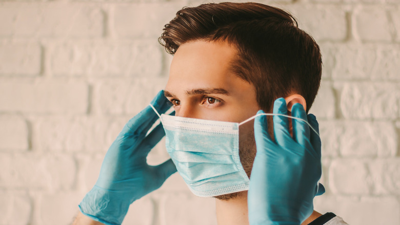 man wearing protective mask and gloves