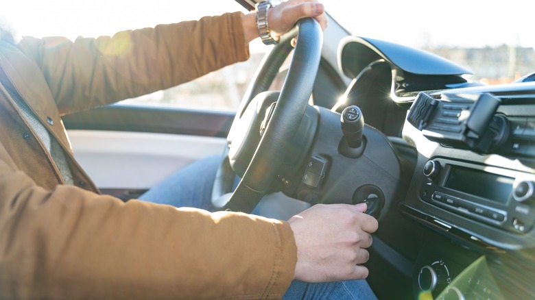 man behind steering wheel