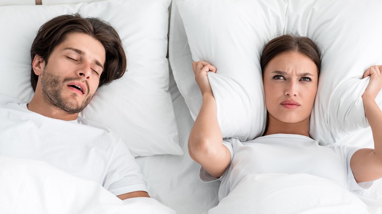 snoring man and frustrated woman