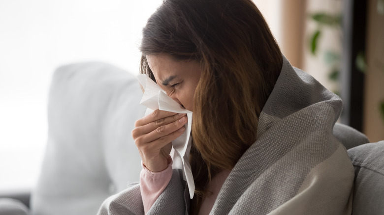 Woman sneezing