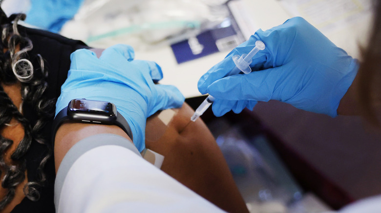 Young Black woman getting a vaccine