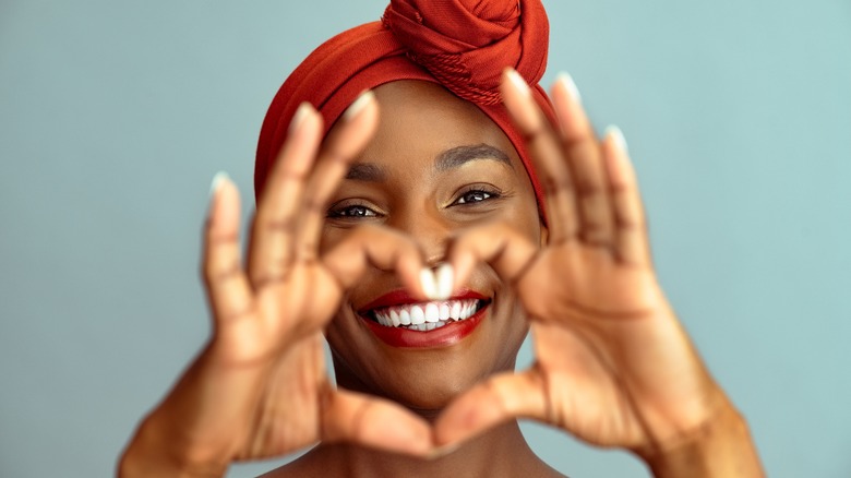 woman making heart shape hands