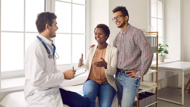 A couple discussing IVF with a doctor